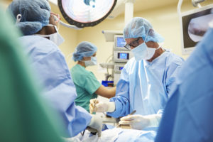 Surgical Team Working In Operating Theatre